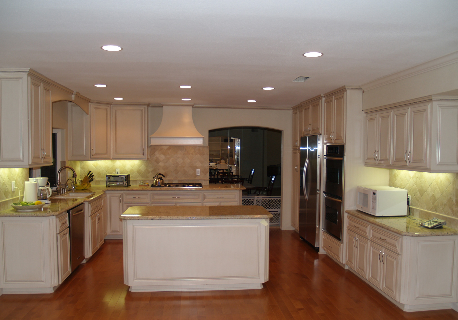 Luxury kitchen remodel Beverly Hills with marble island and pendant lighting